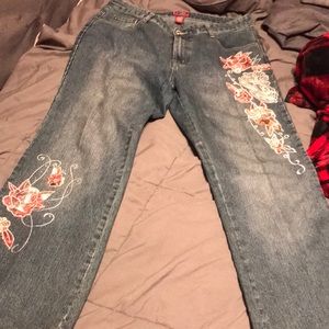 Blue denim jeans with pretty flower print on each leg. Mid rise and comfortable